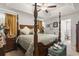 Main bedroom features a four-poster bed with a ceiling fan, sitting area and en suite bathroom at 3500 Church St., Loris, SC 29569