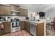 Well-equipped kitchen with stainless steel appliances, granite countertops, wooden cabinets, and a stylish tile backsplash at 3500 Church St., Loris, SC 29569