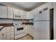 Bright kitchen featuring white appliances, cabinets, and dark countertops at 3555 Highway 544 # 4-C, Conway, SC 29526