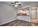 Living room boasts hardwood floors, fan, and an open concept to the kitchen at 3555 Highway 544 # 4-C, Conway, SC 29526