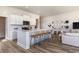 Modern kitchen with island, white cabinetry, and backsplash, complemented by stylish bar stools at 399 Wingspan Ct., Myrtle Beach, SC 29588