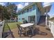 Backyard view showing outdoor seating, a putting green, and access to stairs at 401 25Th Ave. S, North Myrtle Beach, SC 29582