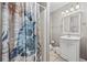 Bathroom with patterned shower curtain, vanity with mirror, and tile flooring at 401 25Th Ave. S, North Myrtle Beach, SC 29582