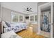 Bright bedroom featuring hardwood floors, a ceiling fan, a window, and an ensuite bathroom at 401 25Th Ave. S, North Myrtle Beach, SC 29582