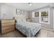 Well-lit bedroom featuring a bed, two dressers, and a view of the outdoor pool at 401 25Th Ave. S, North Myrtle Beach, SC 29582