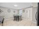 Dining area with glass table, four chairs, neutral walls, and tile flooring at 401 25Th Ave. S, North Myrtle Beach, SC 29582