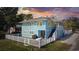 Charming two-story blue house with a white picket fence and outdoor patio area at sunset at 401 25Th Ave. S, North Myrtle Beach, SC 29582