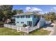 Charming two-story blue house with a white picket fence and outdoor patio area at 401 25Th Ave. S, North Myrtle Beach, SC 29582