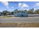 Charming two-story home with white staircases and a vibrant blue exterior at 401 25Th Ave. S, North Myrtle Beach, SC 29582
