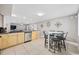 Open concept kitchen with stainless steel dishwasher, tile flooring, bar seating, and view into living area at 401 25Th Ave. S, North Myrtle Beach, SC 29582