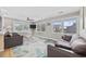 Comfortable living room with sofas, large windows and leafy decor at 401 25Th Ave. S, North Myrtle Beach, SC 29582