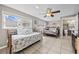 Bright main bedroom with two beds, tile floors, ceiling fan, and ensuite bath at 401 25Th Ave. S, North Myrtle Beach, SC 29582