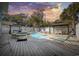 Private pool area with a hot tub, gazebos, lounge chairs, and a spacious deck during sunset at 401 25Th Ave. S, North Myrtle Beach, SC 29582