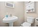 Powder room featuring a modern sink, commode, and charming wall decor at 401 25Th Ave. S, North Myrtle Beach, SC 29582