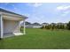 Backyard view showcases a covered patio area, a large green lawn, and privacy landscaping at 4295 Falls Oaks St., Myrtle Beach, SC 29579
