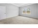Carpeted bedroom with natural light from double windows and a tray ceiling at 4295 Falls Oaks St., Myrtle Beach, SC 29579