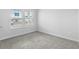 Carpeted bedroom with a view of the neighborhood and ample natural light at 4295 Falls Oaks St., Myrtle Beach, SC 29579