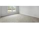 Bright bedroom featuring neutral carpet, a large window, and white trim at 4295 Falls Oaks St., Myrtle Beach, SC 29579