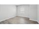 Bedroom with light wood flooring, white trim, and a sunny window at 4295 Falls Oaks St., Myrtle Beach, SC 29579