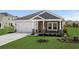 Charming single-story home featuring stone accents, a two-car garage, and well-manicured lawn at 4295 Falls Oaks St., Myrtle Beach, SC 29579