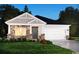 Beautiful home with stone accents, a two-car garage, and attractive landscaping at 4295 Falls Oaks St., Myrtle Beach, SC 29579