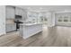 Open kitchen features gray cabinets, stainless steel appliances, and an island, seamlessly connected to the dining area at 4295 Falls Oaks St., Myrtle Beach, SC 29579