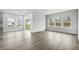 Bright living room with large windows and sliding door to outdoor patio, neutral paint and modern vinyl floors at 4295 Falls Oaks St., Myrtle Beach, SC 29579