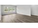Bright living room with large windows, neutral paint and modern vinyl floors at 4295 Falls Oaks St., Myrtle Beach, SC 29579