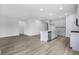 Open-concept living area with wood-look flooring, modern gray kitchen cabinets, and a kitchen island at 4295 Falls Oaks St., Myrtle Beach, SC 29579
