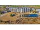 Aerial view of condo complex with a serene pond, landscaping, and lush greenery around the building at 4440 Nassau Ct. # D-507, Little River, SC 29566