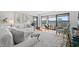 Bright living room with hardwood floors, plush seating, and sliding doors to a balcony with serene waterfront views at 4440 Nassau Ct. # D-507, Little River, SC 29566