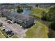 Aerial view of waterfront apartment buildings with parking, landscaping, water feature and nearby community at 4503 W Harbour Ct. # S-6, Little River, SC 29566
