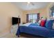 Cozy bedroom with a queen-size bed, ceiling fan, and sliding glass door to the balcony at 4503 W Harbour Ct. # S-6, Little River, SC 29566