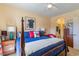 Bedroom featuring a four-poster bed, ceiling fan, and access to the en suite at 4503 W Harbour Ct. # S-6, Little River, SC 29566