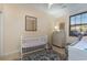 Bedroom with crib, dresser, and comfortable chair by the window, offering a serene space at 4503 W Harbour Ct. # S-6, Little River, SC 29566