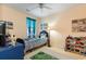 Bedroom with ceiling fan, single bed with toys, play rug and natural light at 4503 W Harbour Ct. # S-6, Little River, SC 29566