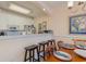 Bright dining area with seating, bar area with stools, and white cabinets at 4503 W Harbour Ct. # S-6, Little River, SC 29566
