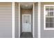 Front entrance of the home with neutral siding and white trim at 4503 W Harbour Ct. # S-6, Little River, SC 29566
