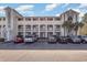 Exterior view of the condo building with parking and palm trees at 4503 W Harbour Ct. # S-6, Little River, SC 29566