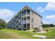 Spacious condo building features multiple balconies, lush landscaping, and well-maintained grounds at 4503 W Harbour Ct. # S-6, Little River, SC 29566