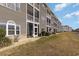 Exterior of condo building with screened in back porches and lawn at 4503 W Harbour Ct. # S-6, Little River, SC 29566