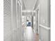 Hallway features tile flooring, white doors, and multiple storage closets, with view through to the front door at 4503 W Harbour Ct. # S-6, Little River, SC 29566