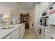 Well-lit kitchen featuring white appliances and eat-in dining area with dark wood furniture at 4503 W Harbour Ct. # S-6, Little River, SC 29566