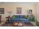 Cozy living room showcasing a blue sofa, artwork, lamps, and a decorative cabinet at 4503 W Harbour Ct. # S-6, Little River, SC 29566