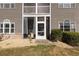 Condo patio with rocking chairs overlooking the yard and shrubbery at 4503 W Harbour Ct. # S-6, Little River, SC 29566