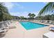 Sparkling community pool surrounded by palm trees and lounge chairs, perfect for hot summer days at 4503 W Harbour Ct. # S-6, Little River, SC 29566