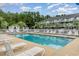 Community swimming pool with lounge chairs and a white fence at 4503 W Harbour Ct. # S-6, Little River, SC 29566