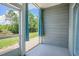 Screened porch overlooking a lush green yard and a tranquil pond, inviting relaxation at 4503 W Harbour Ct. # S-6, Little River, SC 29566