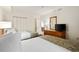 Bright bedroom featuring two twin beds, a dresser, and a television at 4800 S Ocean Blvd. # 204, North Myrtle Beach, SC 29582