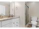 This well-lit bathroom features a single vanity, granite counters and glass enclosed shower at 500 Willow Greens Dr. # 500-G, Conway, SC 29526